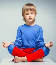 Boy in a suit in lotus position